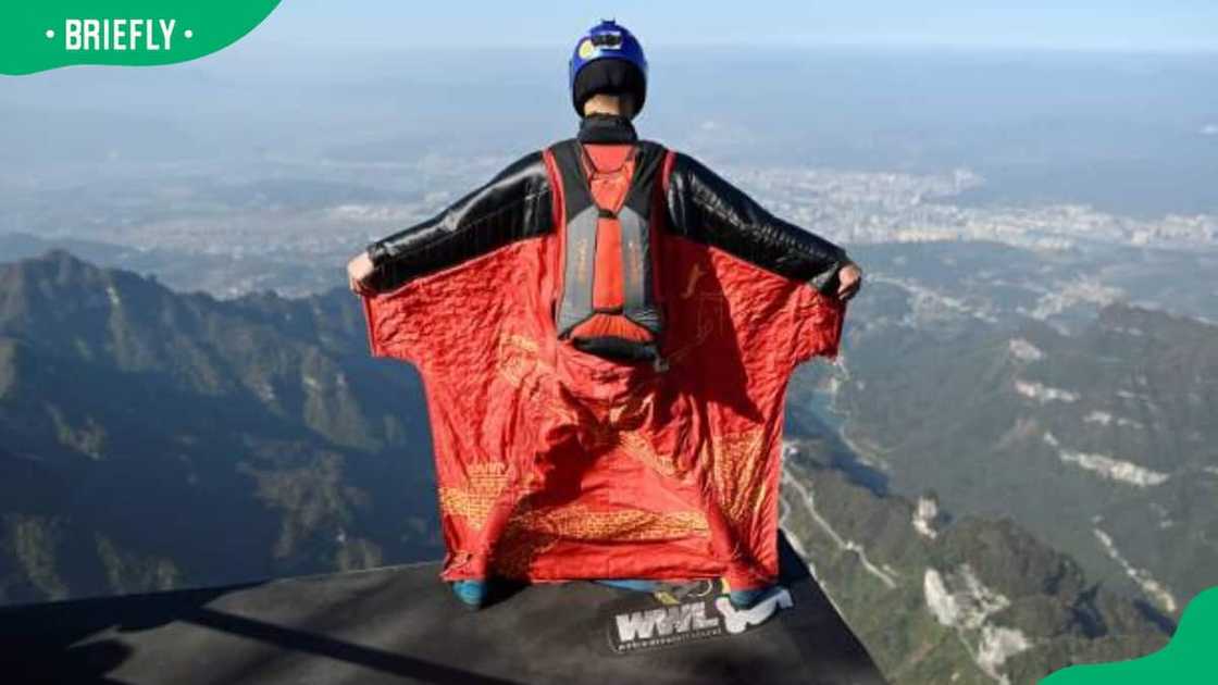 An athlete taking flight in a wingsuit An athlete taking flight in a wingsuit