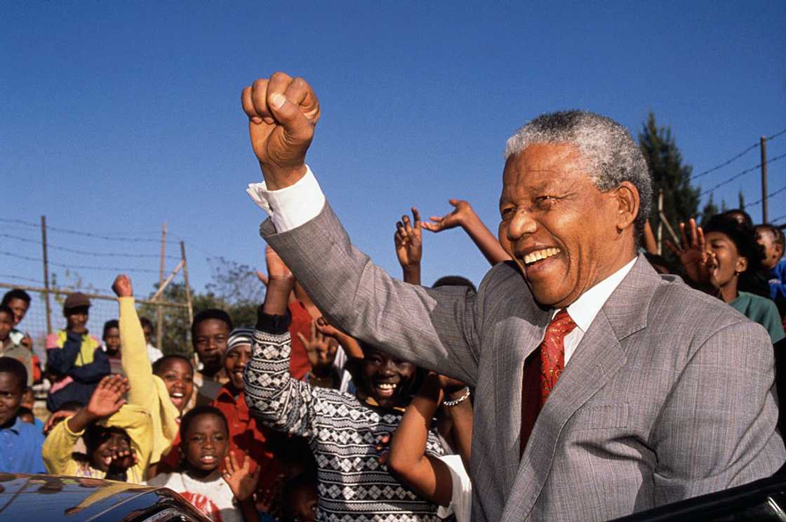 Nelson Mandela raises his fist up as he visits Hlengiwe School Nelson Mandela raises his fist up as he visits Hlengiwe School